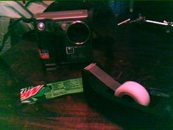 How to upgrade your camera with Mountain Dew Vision™©®℠: 1) rip the label off a Mountain Dew 2) tape it over your flash 3) ??? 4) profit | taken with Palm Zire 72s